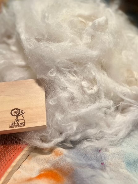 wool with carding paddle.jpg